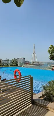 a large swimming pool with a red life preserver at Amazing 4-bedroom Apartment in Dubai