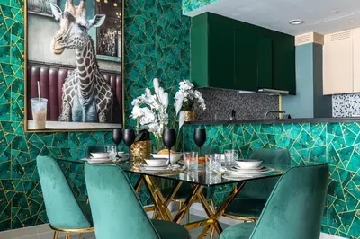 a dining room with a table and green chairs at Luxury Apartments with Rooftop Pool in Paramount Hotel Midtown By Aurora in Dubai