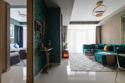 a living room with a blue couch and a bedroom at Luxury Apartments with Rooftop Pool in Paramount Hotel Midtown By Aurora in Dubai
