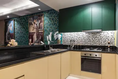 a kitchen with green cabinets and a sink at Luxury Apartments with Rooftop Pool in Paramount Hotel Midtown By Aurora in Dubai