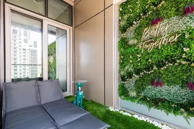a green wall on the side of a building at Luxury Apartments with Rooftop Pool in Paramount Hotel Midtown By Aurora in Dubai