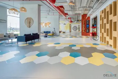 a lobby with a hexagonal floor in a building at Immaculate 1BR at UNA Town Square Dubailand by Deluxe Holiday Homes in Dubai