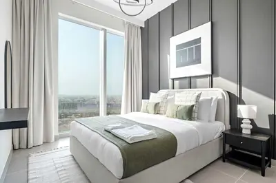 a bedroom with a large bed and large windows at Silkhaus classical 1BDR in Opera District in Dubai