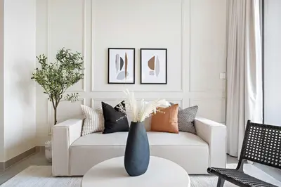 a living room with a couch and a vase on a table at Silkhaus classical 1BDR in Opera District in Dubai