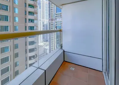 an apartment balcony with a view of a city at StoneTree - Near Tram - Furnished 1BR in Dubai