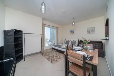 a living room with a table and a couch at StoneTree - Lake View - Family-Friendly Location in Dubai