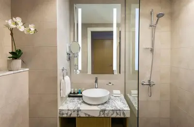 a bathroom with a sink and a shower at DAMAC Maison Aykon City Dubai in Dubai
