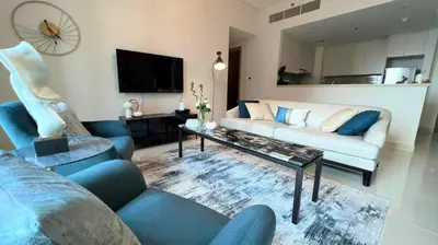a living room with a couch and a coffee table at Luxurious Creek Harbour Apt with Balcony & View in Dubai