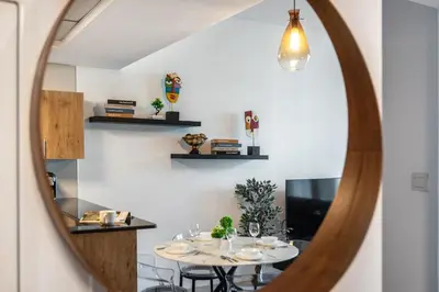 a dining room with a table and a mirror at Cozy Heaven with full Marina View in Dubai