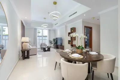 a dining room and living room with a table and chairs at Heaven Crest Vacation Homes Downtown - Studio and 1 Bedroom Suites 2 minute walk to Dubai Mall and Burj Khalifa in Dubai