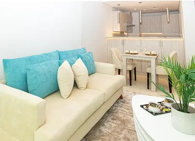 a living room with a couch and a table at Dream Inn - Seven Palm - Free Beach Access in Dubai