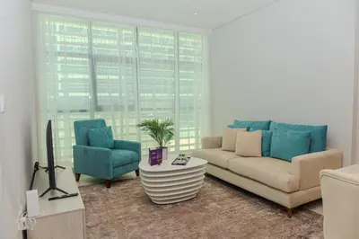 a living room with a couch and two chairs at Dream Inn - Seven Palm - Free Beach Access in Dubai