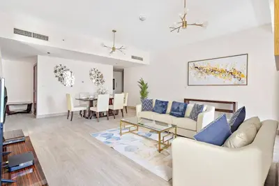 a living room with a couch and a table at StoneTree - Near Beach - Furnished 1BR with Partial Sea View in Dubai
