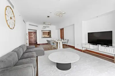 a living room with a couch and a table at StoneTree - 2 BR apartment in Golden Mile 6 Near Nakheel Mall in Dubai