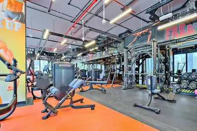 a gym with several rows of exercise equipment in it at StoneTree - New stylish 1 BR Apartment in JLT in Dubai