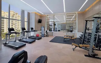 a gym with several treadmills and machines in a building at StoneTree - Spacious 1 BR with Stunning Sea View in Palm Jumeirah in Dubai