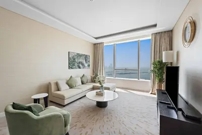 a living room with a couch and a table at StoneTree - Spacious 1 BR with Stunning Sea View in Palm Jumeirah in Dubai