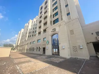a large white building with a large door on it at StoneTree - Luxurious 2 BR Apartment in Palm Jumeirah in Dubai