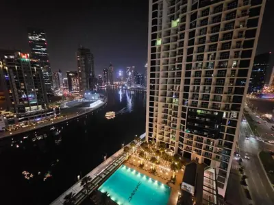 a view of a large building at night with a river at Luxury Business Bay Studio with breathtaking views. in Dubai