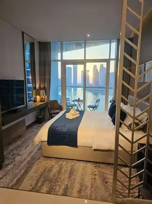 a bedroom with a bed with a view of the water at Luxury Business Bay Studio with breathtaking views. in Dubai
