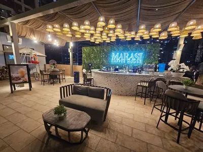 a restaurant with a bar with tables and chairs at Luxury Business Bay Studio with breathtaking views. in Dubai