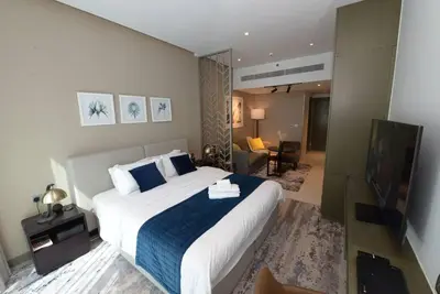 a hotel room with a large bed and a television at Luxury Business Bay Studio with breathtaking views. in Dubai