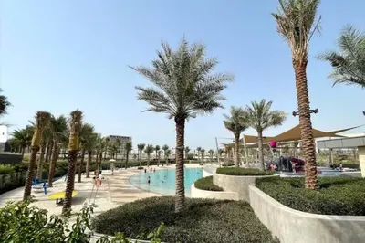 a resort with a swimming pool and palm trees at 2bedroom apartment Dubai Hills in Dubai