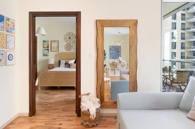 a living room with a couch and a mirror at Boutique Apartment Sea Views - Dubai Marina in Dubai