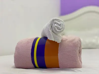 a towel roll with a towel on top of it at Single Partition Room in Al Barsha 1 Near Mashreq Metro in Dubai