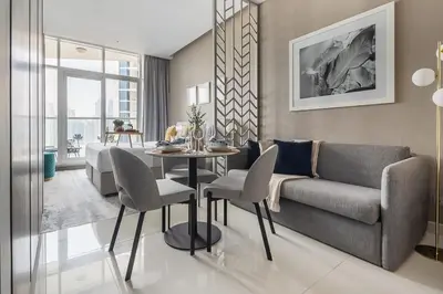 a living room with a couch and a table at Frank Porter - Damac Prive B in Dubai