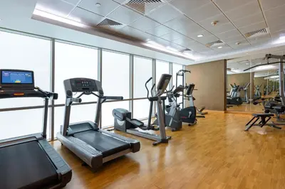 a gym with treadmills and cardio equipment in a building at Upgraded 1BR on a high floor of Liberty House,DIFC - Allsopp&Allsopp in Dubai