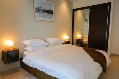 a bedroom with a large white bed with two pillows at Deluxe 1 Bedroom Apartment - Elite Residence Dubai Marina - Sea View in Dubai