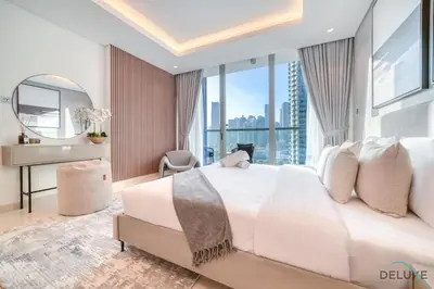 a bedroom with a large white bed and a mirror at Exclusive Offer Cozy Stay with Burj Khalifa Views by Deluxe Holiday Homes in Dubai