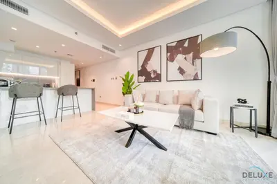 a living room with a couch and a table at Exclusive Offer Cozy Stay with Burj Khalifa Views by Deluxe Holiday Homes in Dubai