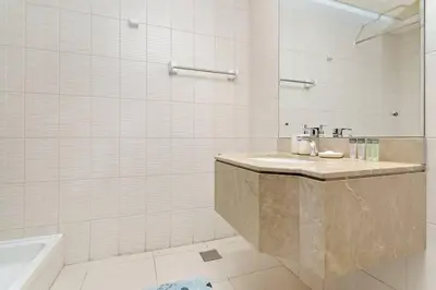a bathroom with a sink and a bath tub at StoneTree - Near Metro - Furnished Studio in JLT in Dubai