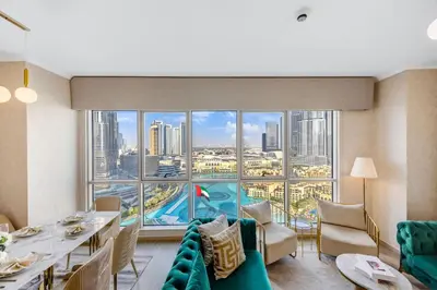 a dining room with a view of the city at Durrani Homes - Grandiose 5BR Besides Dubai Mall with Burjkhalifa and Fountain view in Dubai