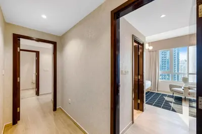 a hallway with a mirror and a living room at Durrani Homes - Grandiose 5BR Besides Dubai Mall with Burjkhalifa and Fountain view in Dubai