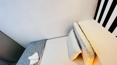 a bunk bed with a pillow on it in a room at Strips Partition Room Al barsha 1 Near MOE Metro in Dubai