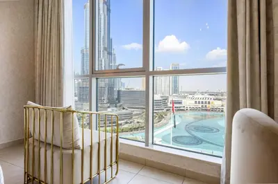 a room with a large window with a view of the city at Durrani Homes - Lavish 3BR Besides Burj Khalifa and Fountain view in Dubai