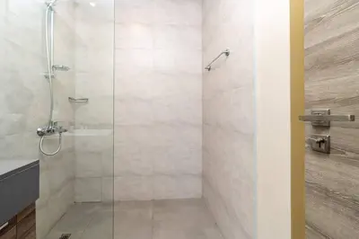 a shower with a glass door in a bathroom at Bloom Heights: Pool, Gym & Wi-Fi - JVC - Dubai in Dubai