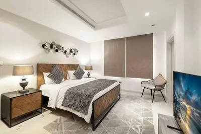 a bedroom with a large bed and a chair at 6 Bedroom Modern Luxury Villa In Palm Jumeirah in Dubai