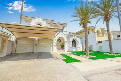 a large house with palm trees in front of it at 6 Bedroom Modern Luxury Villa In Palm Jumeirah in Dubai