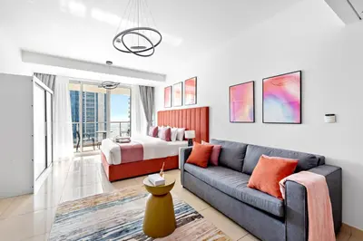 a living room with a couch and a bed at StoneTree - Modern Stylish Studio in JLT in Dubai