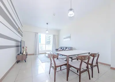 a dining room with a table and chairs at StoneTree - Spacious 1BR - Best Location for Tourist in Dubai
