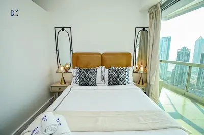 a bedroom with a large bed and a large window at Luxury Escapes - Newly furnished 1BR Apartment - 8 BLVD WALK DOWNTOWN in Dubai