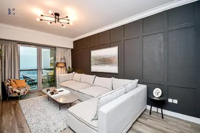 a living room with a white couch and a table at Luxury Escapes - Newly furnished 1BR Apartment - 8 BLVD WALK DOWNTOWN in Dubai