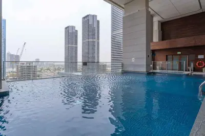 a swimming pool on top of a building with tall buildings at Lovely Lake View - Two Bedroom - JLT in Dubai