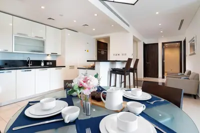 a kitchen and dining room with a table and chairs at Lovely Lake View - Two Bedroom - JLT in Dubai
