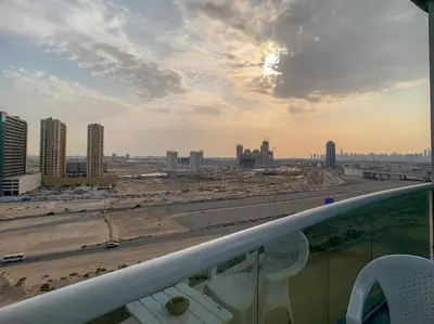 a view of a city from the balcony of a building at StoneTree - Furnished Studio in Peaceful Location in Dubai