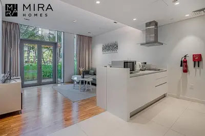 a kitchen with white cabinets and a counter top at Mira Holiday Homes - Serviced 1 bedroom in Bluewaters in Dubai